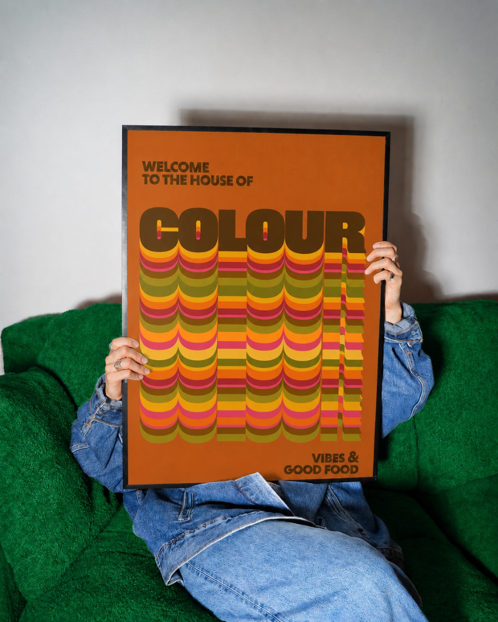 House of Colour print, orange, framed on a green sofa
