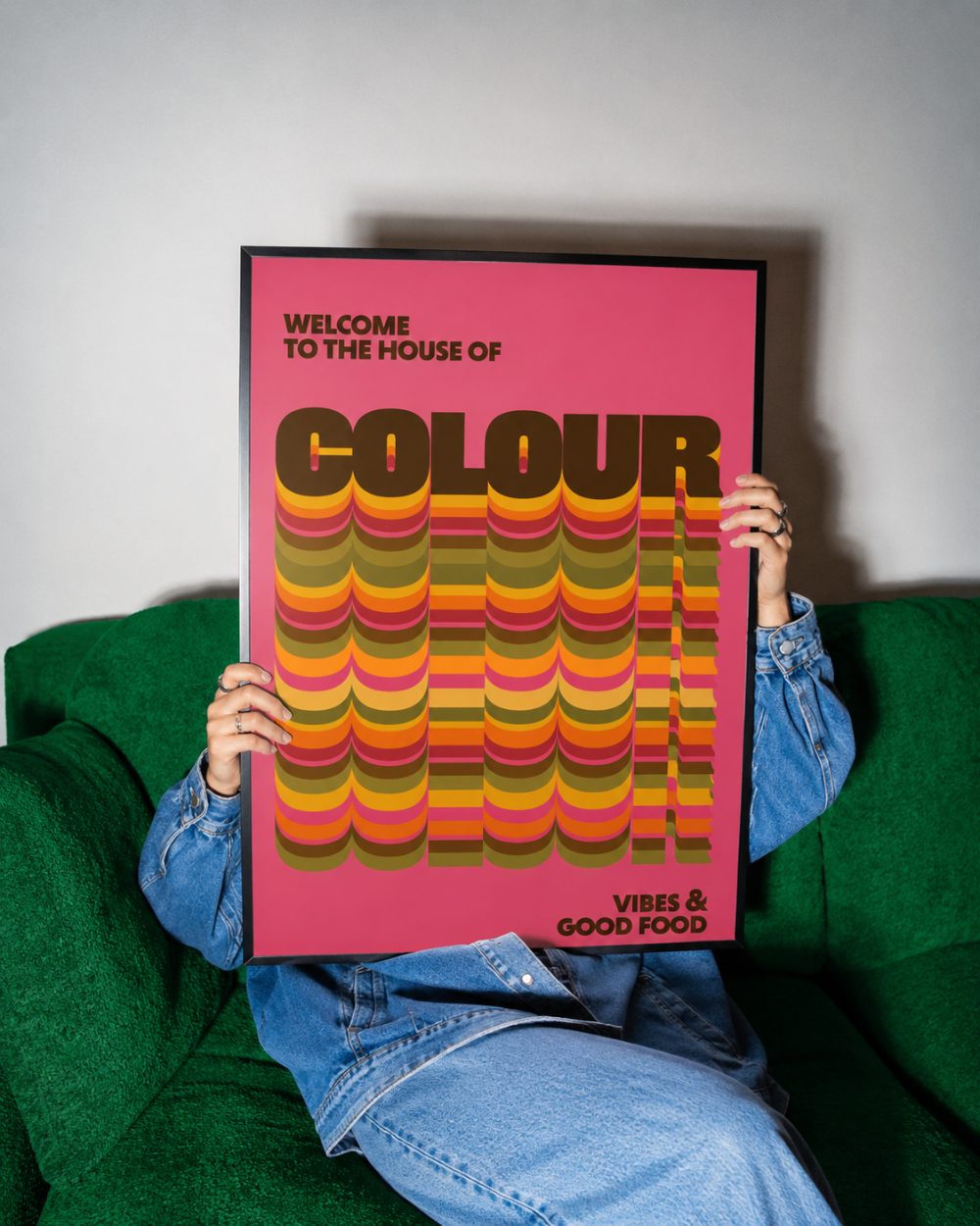 House of Colour print, pink, framed on a green sofa